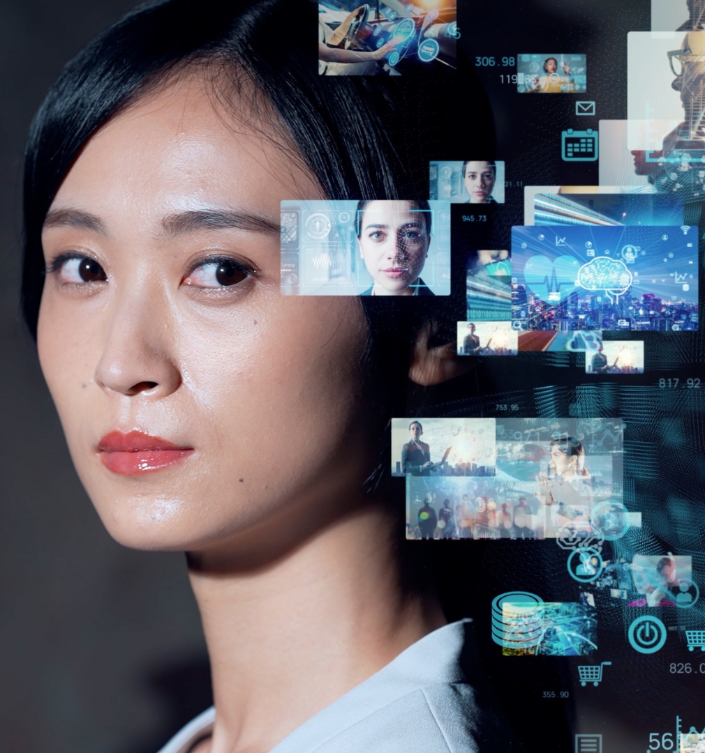 Female digital media analyst looking directly at the camera, surrounded by digital marketing data-related pictures