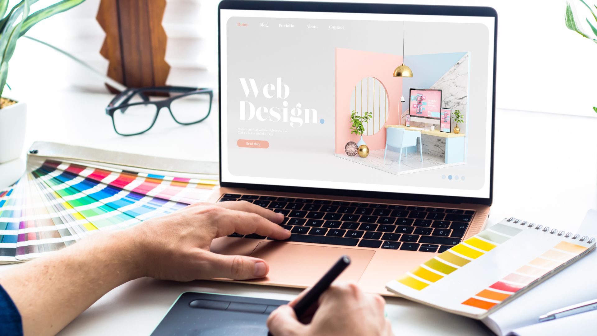 An ui/ux designer from a well-known digital agency in Bali is creating compelling visuals for a website design using a rose gold mac laptop and a huge selection of color pallets