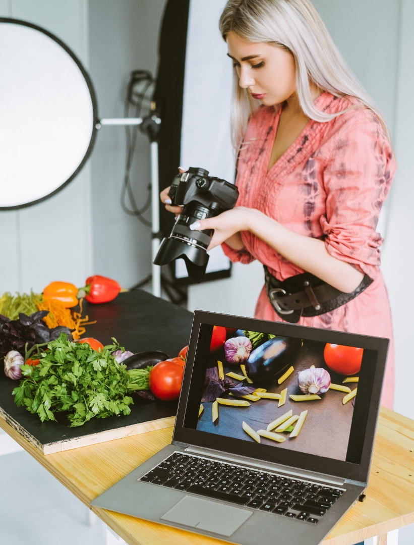 A-silver-hair-female-model-in-pink-dress-is-taking-a-picture-of-foods-ingredients-in-her-studio-to-give-a-food-promotion-ideas-to-the-audience