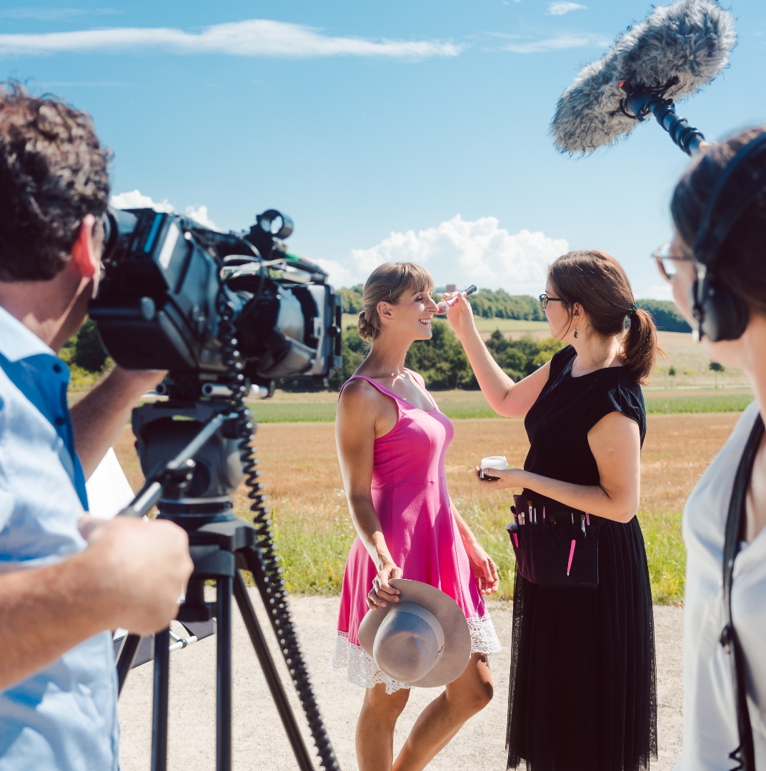 a female model with pink dress with make up artist and two videographer crews preparing for the hotel videography shooting