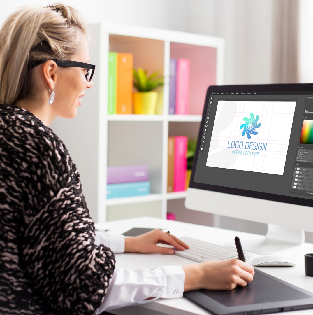 a professional woman with blonde hair and eye glasses look at to the monitor for hotel logo creative service