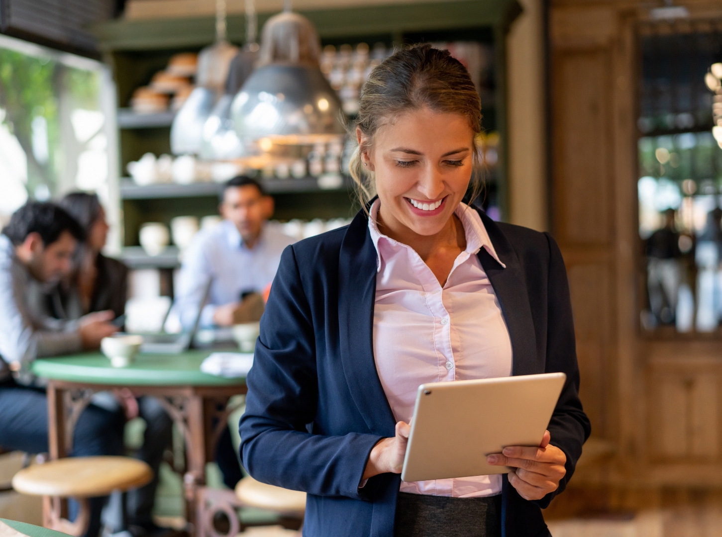 female-latina-model-with-with-suit-hold-her-ipad-and-look-at-her-restaurant-facebook-page