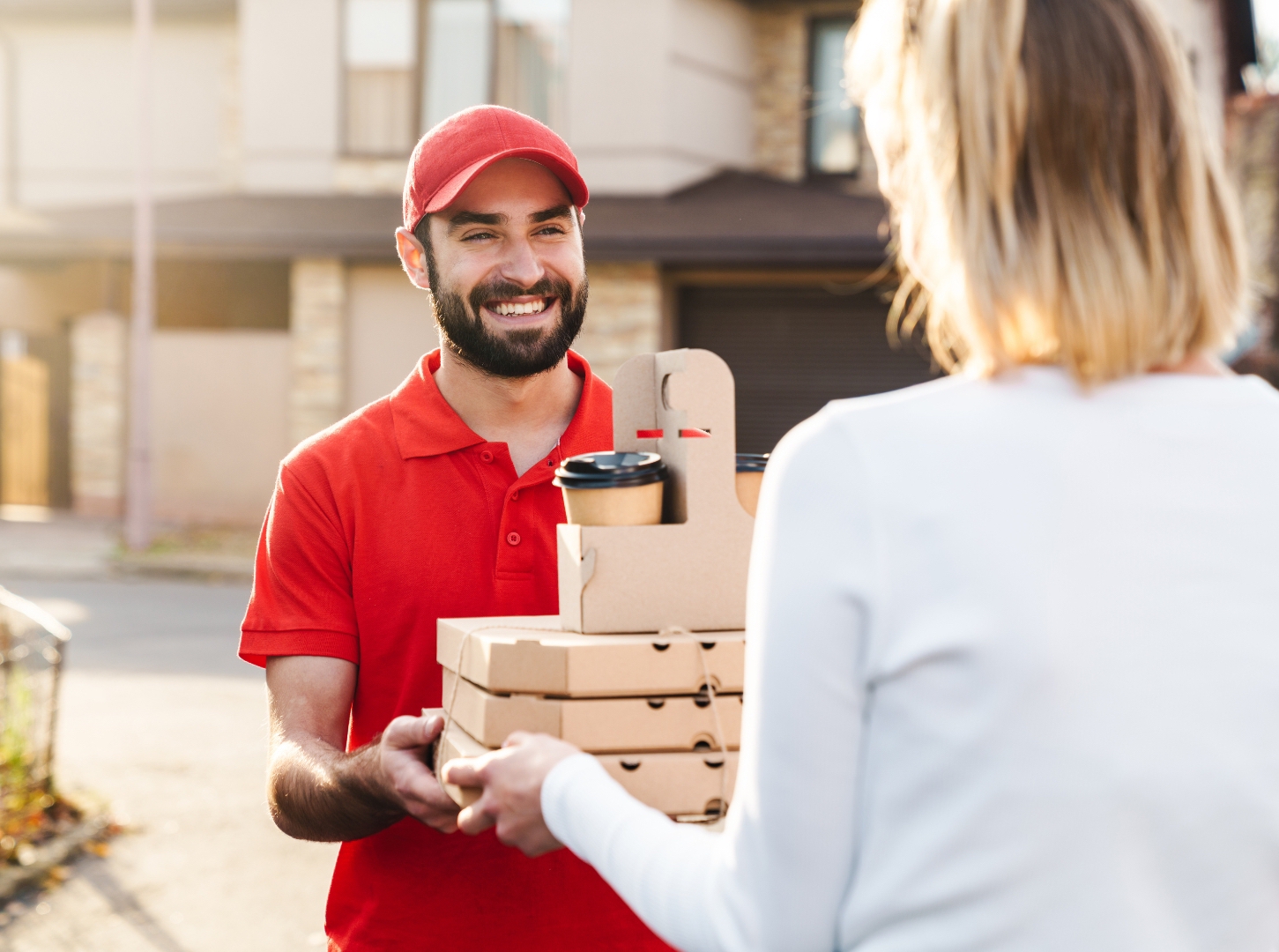 handsome-delivery-guy-with-red-hat-and-red-polo-shirt-give-the-ordering-foods-to-the-female-customer