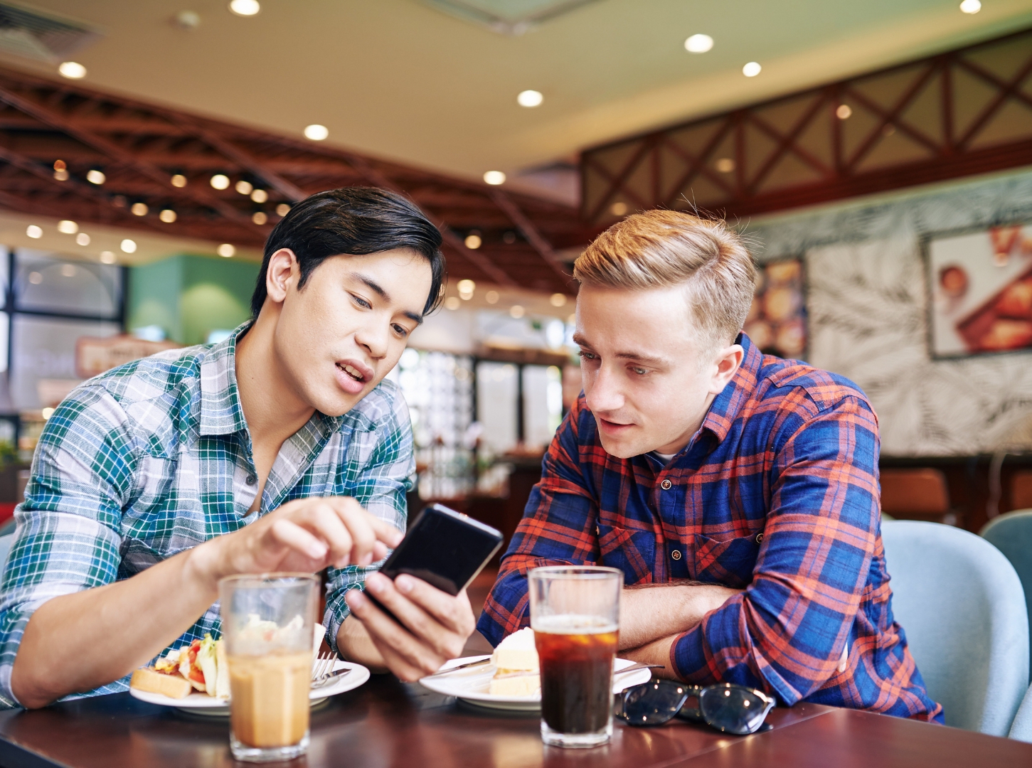 one-asian-male-and-one-europe-male-are-discussing-about-the-restaurant-mobile-app