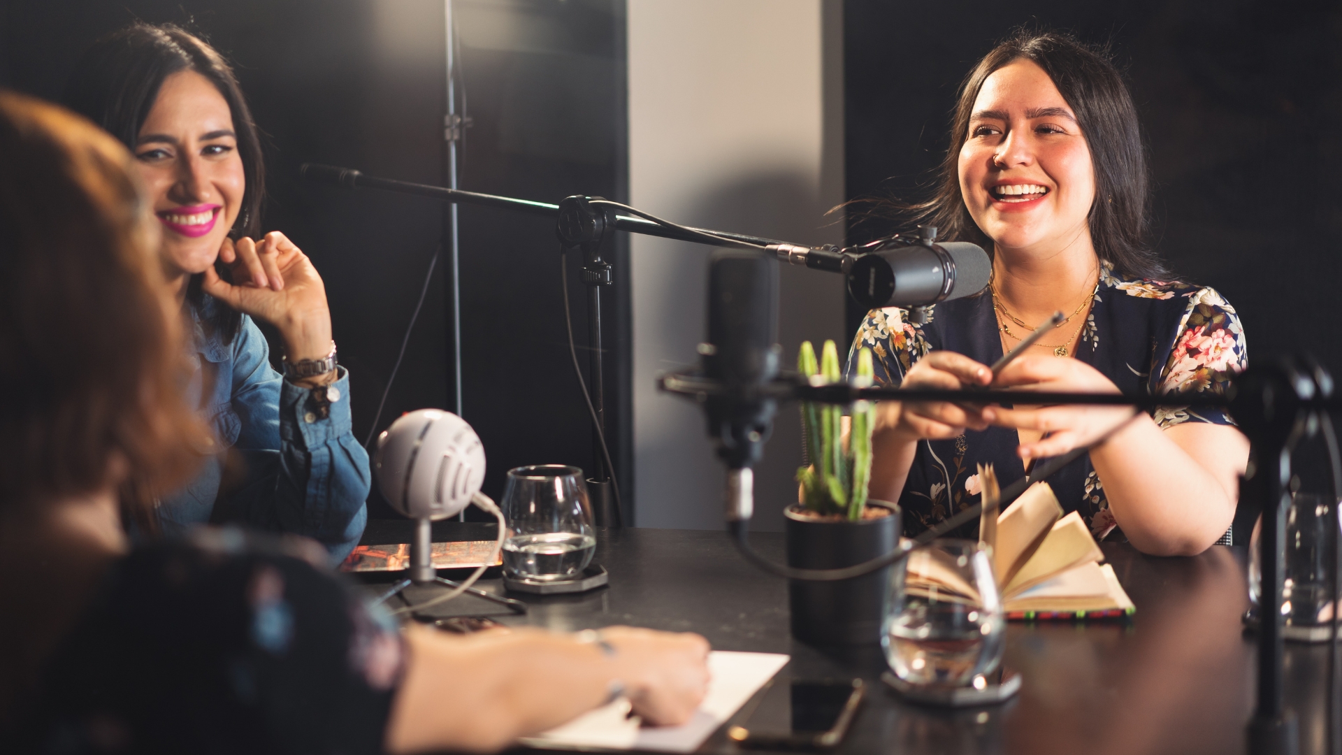 three women smile to each other in the podcast studio rental